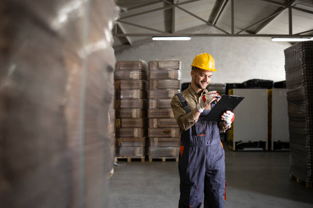 istock Warehouse worker controlling new palettes arriving in the storage. 1314851347