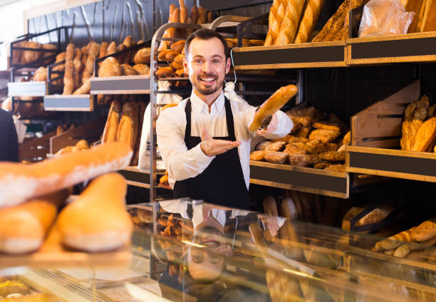 istock Seller offers to try a baguette 1314851805