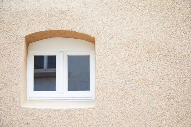 istock white arched small wooden window in a concrete wall 1314855490