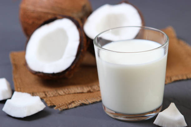 istock Milk and broken coconuts on the table. Vegetable milk, a veggie drink. 1314858592