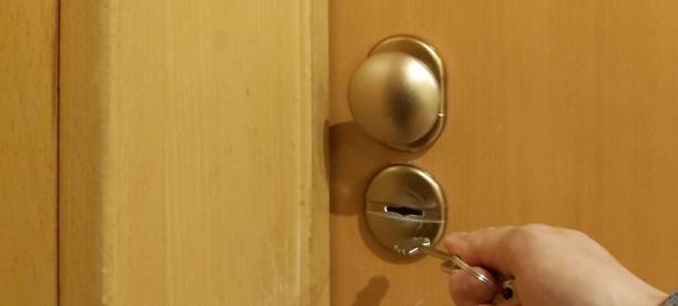istock Hand opening the door with keys 1314863280