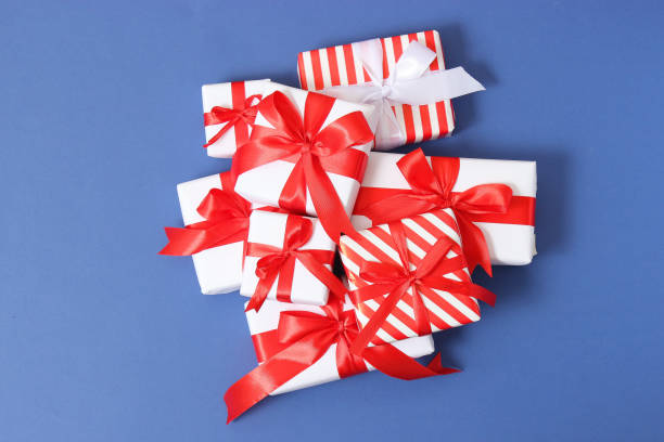 istock Set of beautifully wrapped gift boxes on a colored background top view. 1314864332