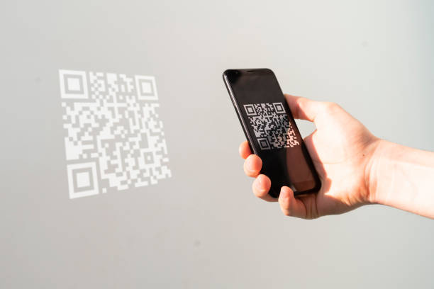 istock hand holding a smartphone and scan the qr code to make a payment 1314869249
