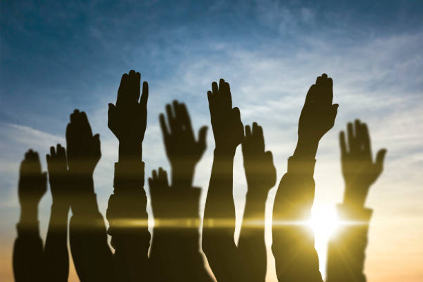 istock people hands raised in the air, vote, election, democracy 1314869305