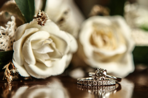 White gold wedding ring on flower background