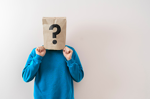 a person with a paper bag on the head with question mark, sign symbol of problem