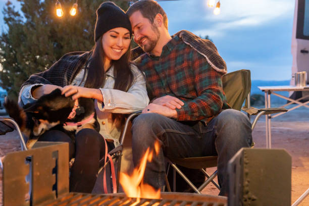 istock Young Smiling Couple Enjoying A Romantic Evening By The Campfire , Closeup 1314871644