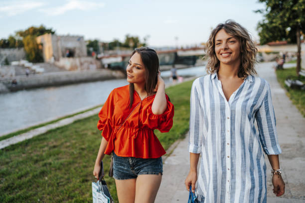istock Female friends walking by the river 1314872613