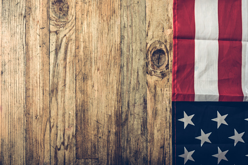 Close-up shot of American flag on wood background