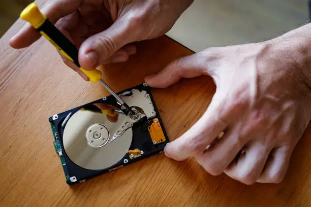 Data hard drive backup. Repair hdd disk on wooden table