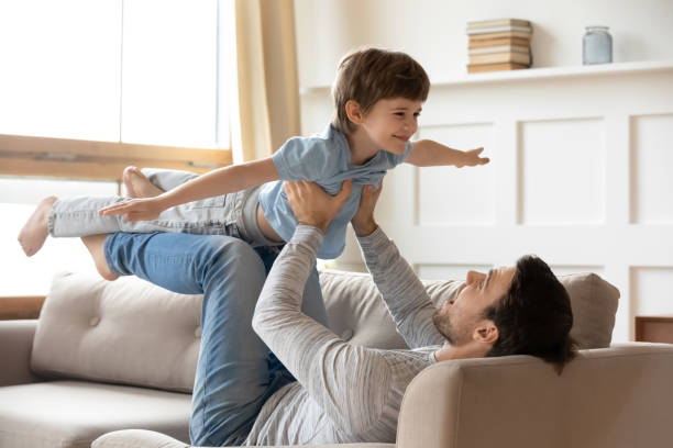 istock Happy young dad and small son play at home 1314877372