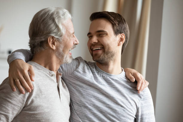 istock Smiling mature father and adult son hugging 1314877573