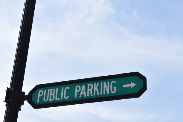 istock Public parking sign with arrow placed at the bottom of the image to include ad space 1314879664