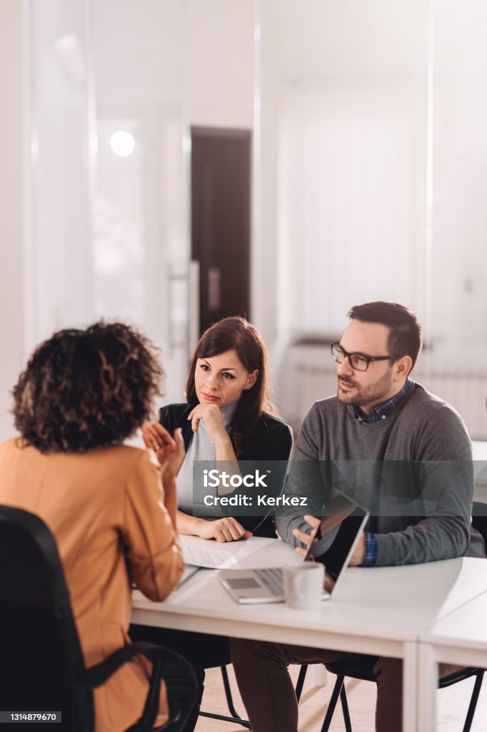 Couple consulting with a female financial manager at the bank Couple consulting with a female financial manager at the bank about real estate loan Financial Advisor Stock Photo