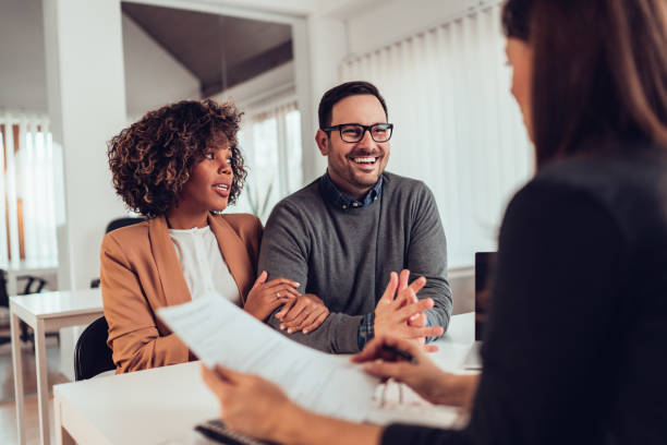 istock Happy couple talking with sales manager 1314879688
