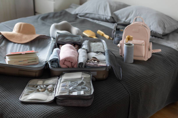 istock Suitcase technique wires equipment on bed. Package or storage with stuff, clothes and accessories 1314879690