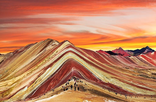 Rainbow mountain or Vinicunca Montana de Siete Colores with beautiful evening sunset sky, Cuzco or Cusco region in Peru, Peruvian Andes mountains, panoramic view