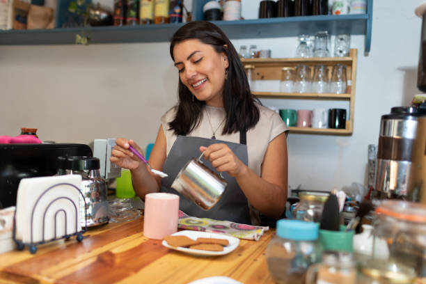 istock Beautiful smiling barista serving coffee and biscuits in cafeteria 1314883715