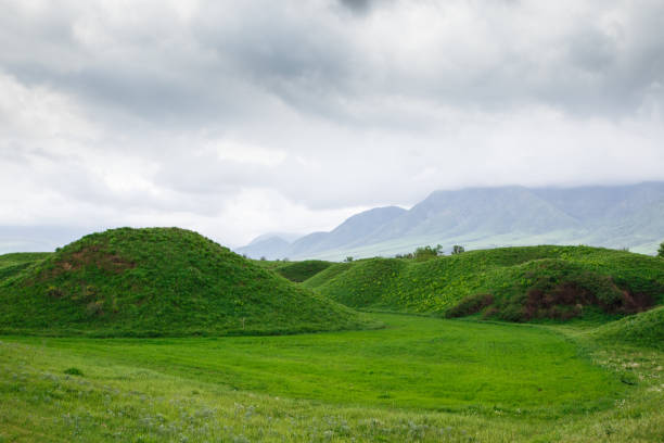 istock Landscape summer and spring. Bright green grass on the round hills. Clouds before the rain. Clouds in the sky. Tourism travel. 1314883897