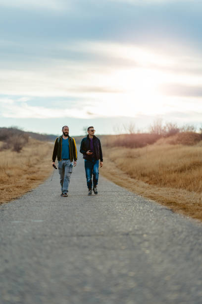 istock Friends hiking down the road 1314884225