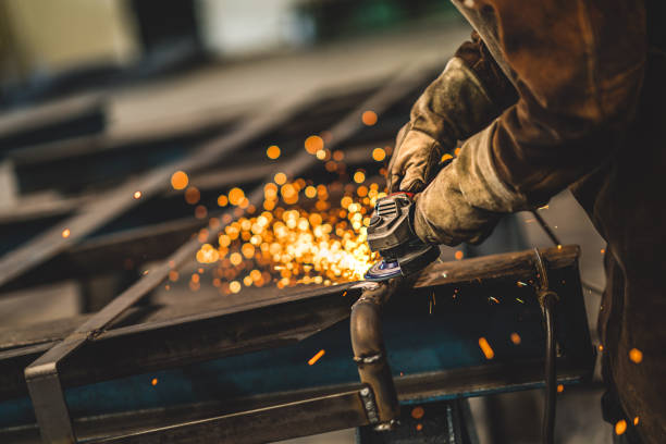 factory worker grinding a metal,close up - indústria metalúrgica imagens e fotografias de stock