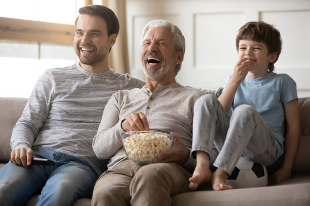 istock Overjoyed three generations of men watch TV 1314886695