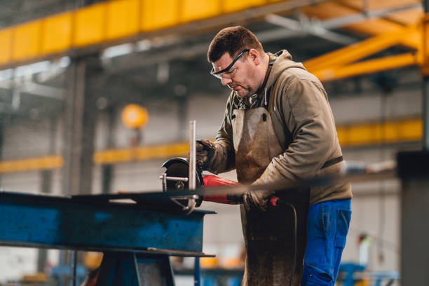 istock Factory worker cutting metal with grinder. 1314887343