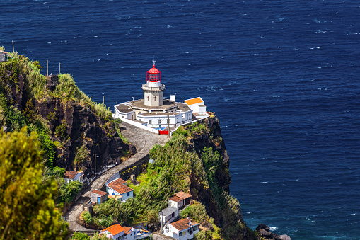 Dramatic view down to lighthouse on Ponta do Arnel, Nordeste, Sao Miguel Island, Azores, Portugal. Lighthouse Arnel near Nordeste on Sao Miguel Island, Azores, Portugal.