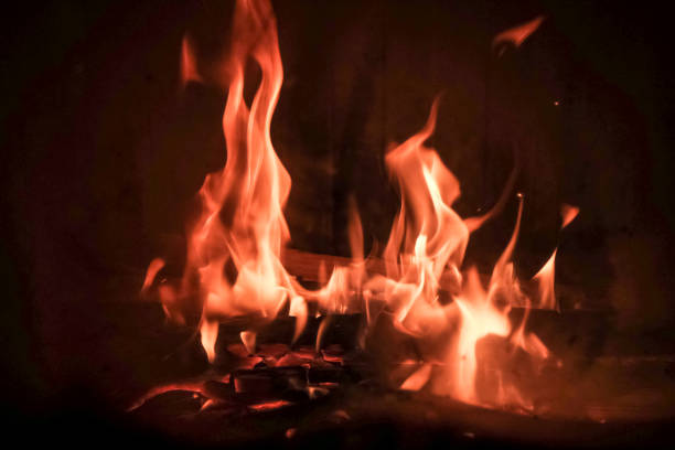 istock Burning fire with red, orange and yellow flames background. Arson, fire safety and danger theme. Camp fire in the night. Burning firewood in the fireplace 1314888199