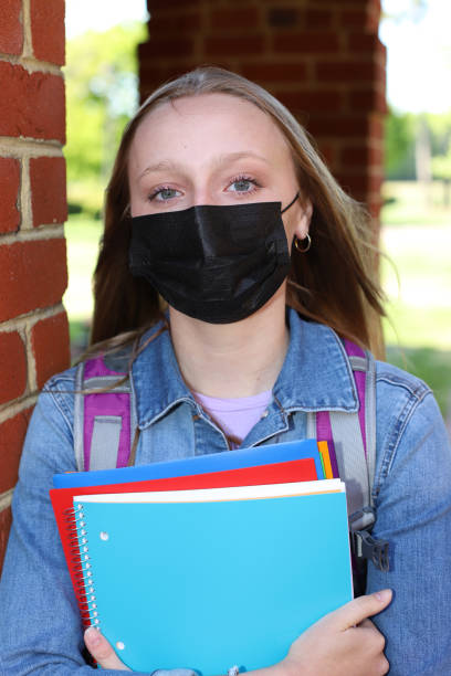 istock Caucasian female high school student stands on campus grounds getting ready for school 1314888884