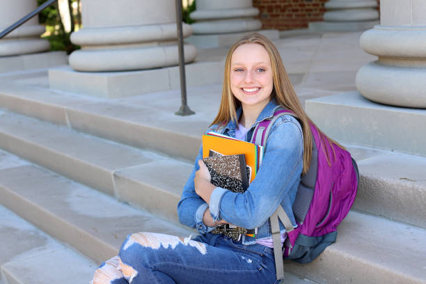 istock Caucasian female high school student stands on campus grounds getting ready for school 1314888975