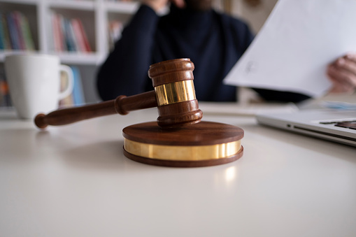 Lawyer in office with gavel, symbol of justice