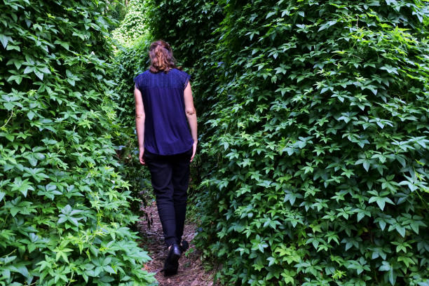 istock Woman walking in a narrow path in rainforest 1314895492