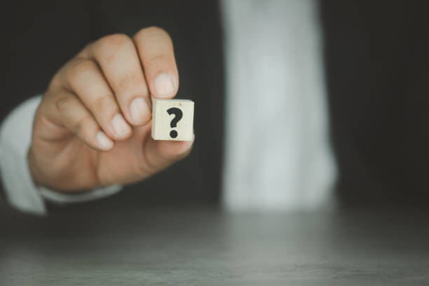 istock Businessman showing question mark on wooden cube. Communication and brainstorming concepts 1314897149
