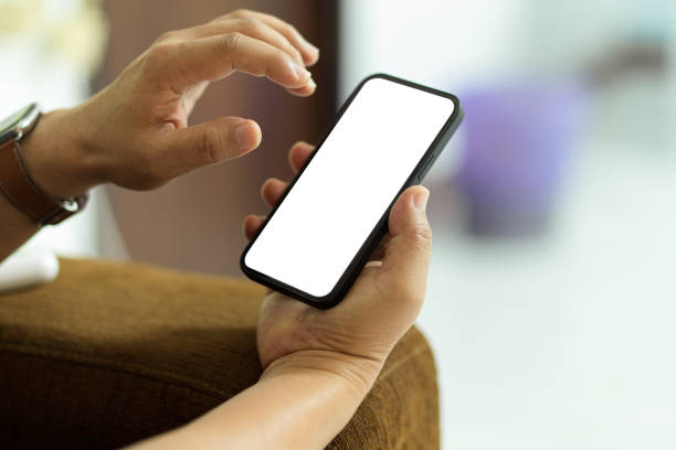 istock Close up view of male hand using smartphone with mock-up screen in blurred background 1314900357
