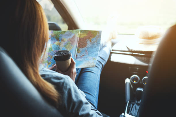 istock A young woman reading a map for direction and drinking coffee in the car 1314902701