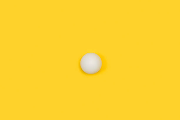 istock A white ping pong ball on a yellow background 1314903287