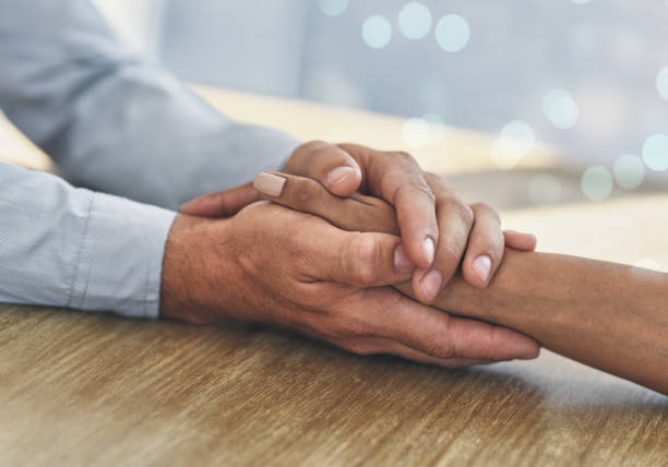istock Closeup shot of two unrecognisable people holding hands 1314904226