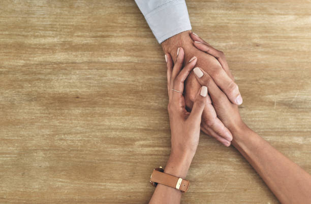 istock Closeup shot of two unrecognisable people holding hands 1314904234