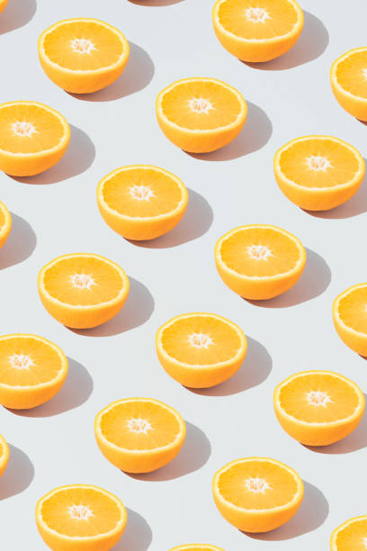 istock Pattern made with fresh sliced orange on the gray background. Minimal fruit or food concept. Flat lay, top view. 1314904515