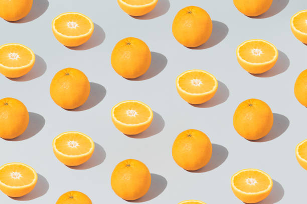 istock Pattern made with fresh orange and sliced on the gray background. Minimal fruit or food concept. Flat lay, top view. 1314904529