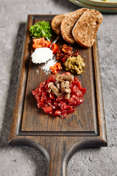 istock Beef tartare on wooden plate 1314904573