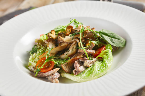istock Oyster mushrooms and meat salad plate 1314904664