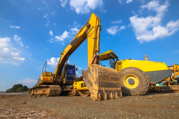 istock Backhoe, grader and road roller on the ground at site construction. 1314904682