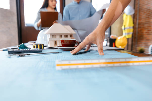 istock industry manager, engineer, businessman reading and checking blueprint, drawing plan in the room in office. 1314905560