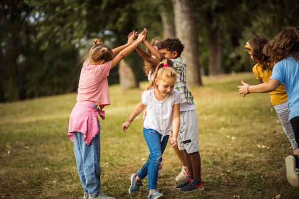 istock Large group of school kids having fun in nature. 1314907412
