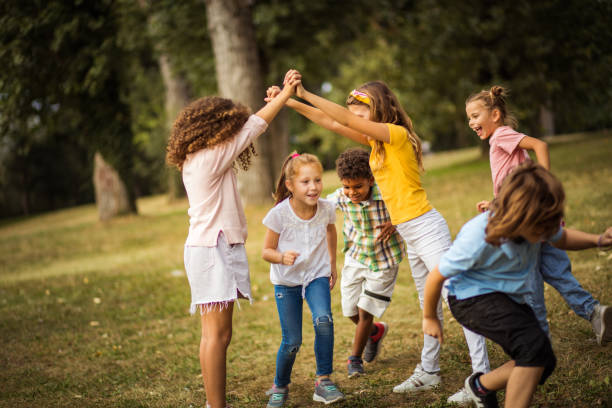 istock Large group of school kids having fun in nature. 1314907495