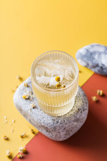 Hard seltzer cocktail with chamomile and ice Hard seltzer cocktail with chamomile and ice on a table. Summer refreshing beverage, drink soda water glass lemon stock pictures, royalty-free photos & images