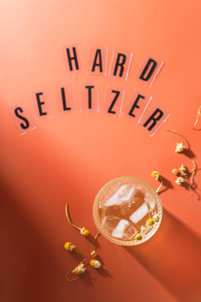 Hard seltzer cocktail with chamomile and ice Hard seltzer cocktail with chamomile and ice on a table. Summer refreshing beverage, drink soda water glass lemon stock pictures, royalty-free photos & images