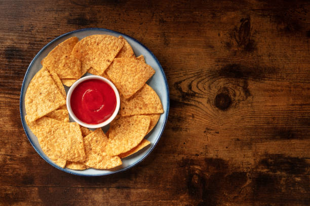istock Nacho chips with a dip, shot from the top on a rustic wooden background 1314911305